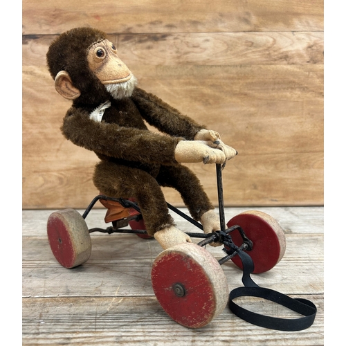 627 - Steiff monkey on a tricycle pull along toy with metal tag to ear