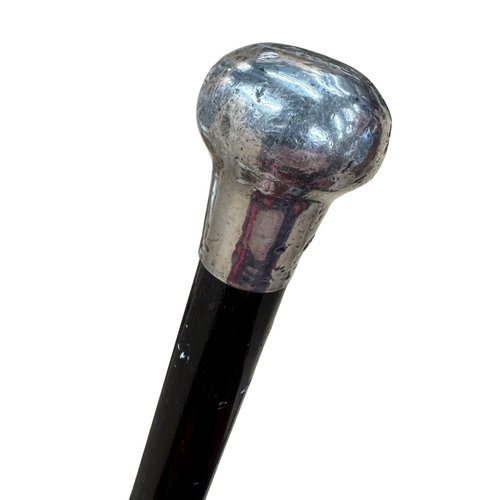 473 - Antique silver capped gentleman's dress cane, having simple flared design with black wooden shaft, L... 