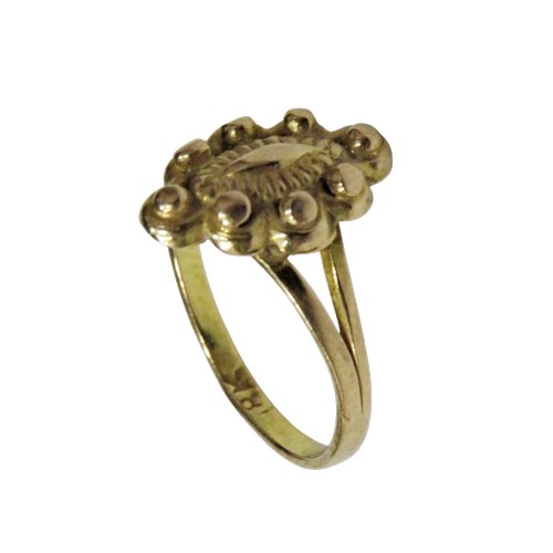12 - A Continental yellow-metal shaped-oval ring, the head decorated with a marquise-shaped panel within ... 