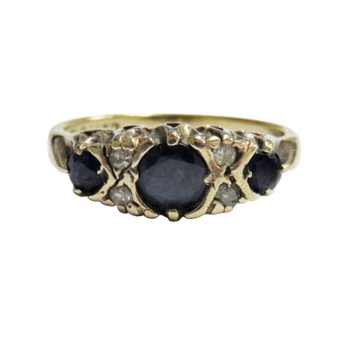 16 - A vintage 9ct gold, sapphire and diamond dress ring, the three graduated oval and round dark-blue/bl... 