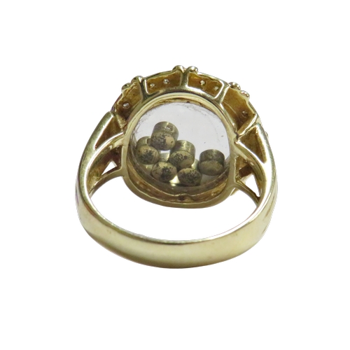 17 - A Continental multi-gem ring resembling a 'happy diamonds' glazed cluster, the shaped-round head enc... 