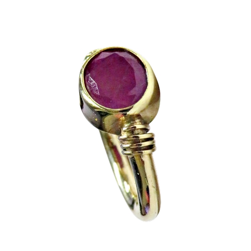 18 - A Continental fracture-filled-ruby single stone ring, the oval mixed-cut opaque stone approx. 10mm x... 