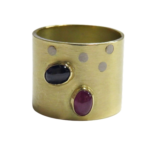 21 - A hand-made modernist cabochon ruby and sapphire broad-band ring, the oval cabochons each rub-over s... 