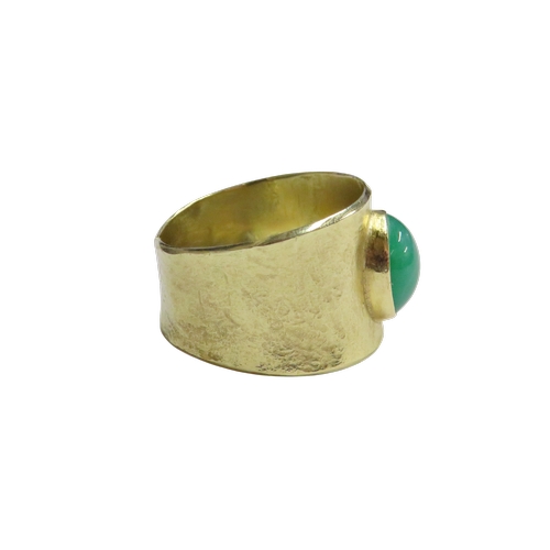 22 - A 1970's modernist chrysoprase single stone broad-band ring, the oval cabochon rub-over set within a... 
