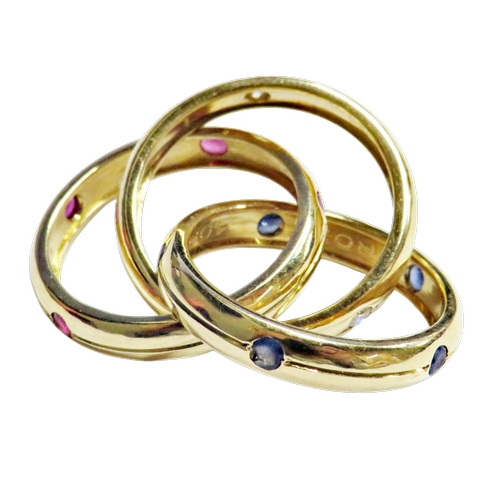 24 - Cartier, a vintage 18ct gold, ruby, sapphire and diamond 'Constellation' trilogy ring, import hallma... 