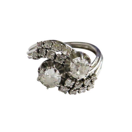 27 - A mid 20th century Continental diamond cross-over ring, possibly French, the two principle old-cut s... 