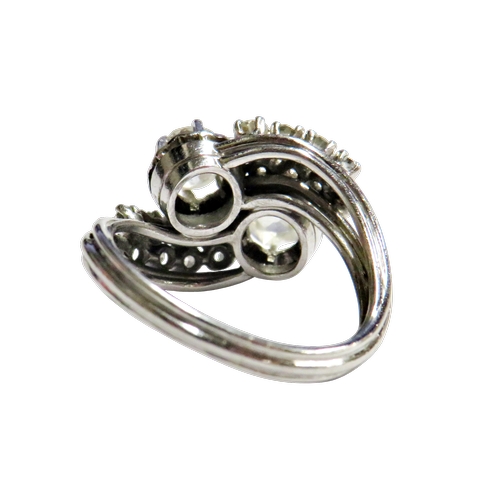 27 - A mid 20th century Continental diamond cross-over ring, possibly French, the two principle old-cut s... 