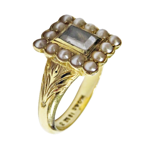 33 - An early 20th century gold and half-pearl mourning ring, the rectangular head with a central glazed ... 