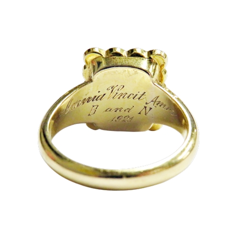 33 - An early 20th century gold and half-pearl mourning ring, the rectangular head with a central glazed ... 