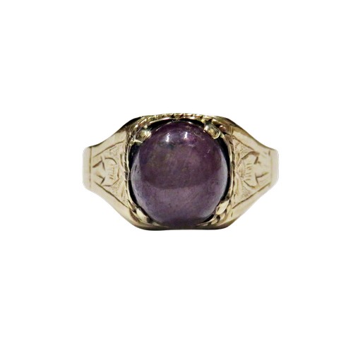 36 - A vintage gold and oval 'star' ruby single stone ring, the purple / red cabochon displays a weak sta... 