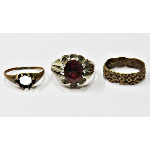 38 - Four various rings comprising, a silver and oval garnet single stone gypsy ring, size S+; a floral-t... 