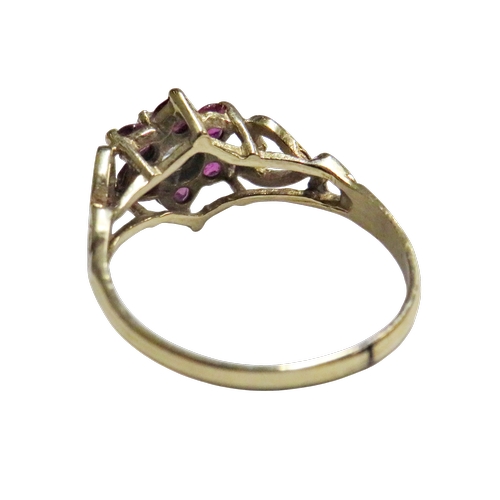 40 - A vintage ruby and diamond cluster ring, centred with a small old-cut diamond approx. 0.15cts, withi... 