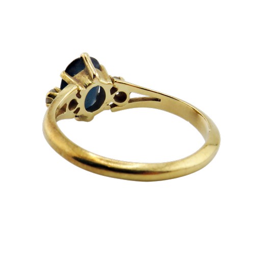 41 - A vintage French gold, sapphire and diamond three stone ring, centred with a very dark blue/black ov... 