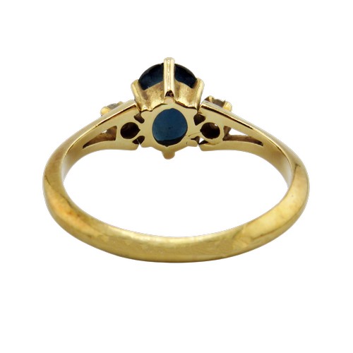 41 - A vintage French gold, sapphire and diamond three stone ring, centred with a very dark blue/black ov... 