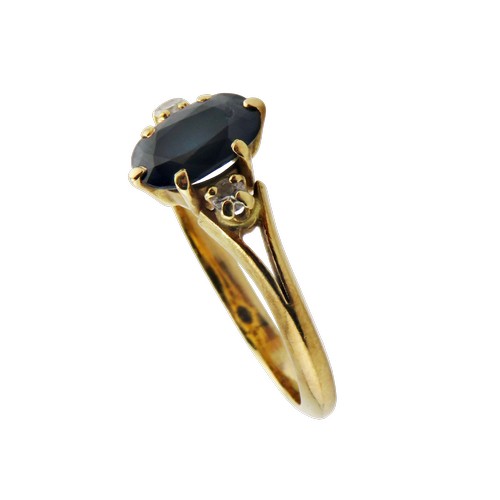 41 - A vintage French gold, sapphire and diamond three stone ring, centred with a very dark blue/black ov... 