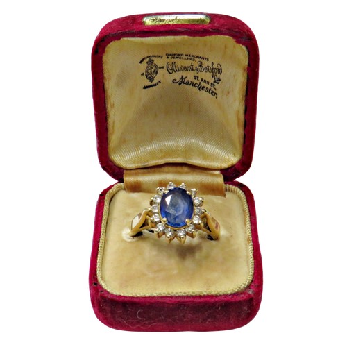 49 - A vintage Continental sapphire and diamond oval cluster ring, centred with a pale-blue oval mixed-cu... 