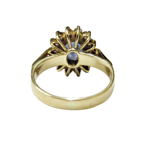 49 - A vintage Continental sapphire and diamond oval cluster ring, centred with a pale-blue oval mixed-cu... 