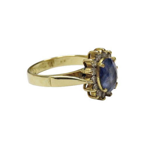 49 - A vintage Continental sapphire and diamond oval cluster ring, centred with a pale-blue oval mixed-cu... 