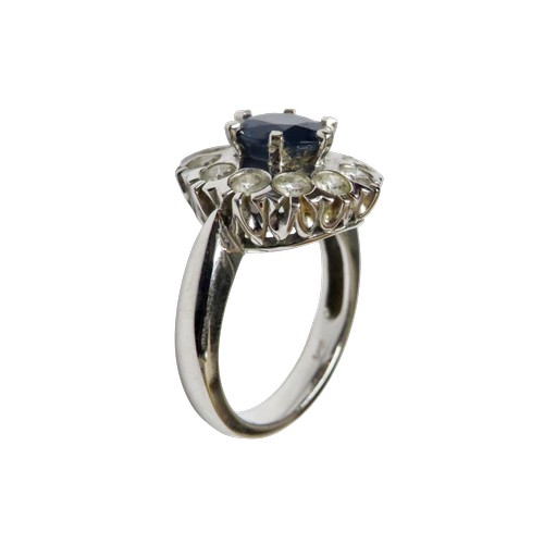 50 - An 18ct white gold, sapphire and diamond cluster ring, centred with a round mixed-cut sapphire appro... 