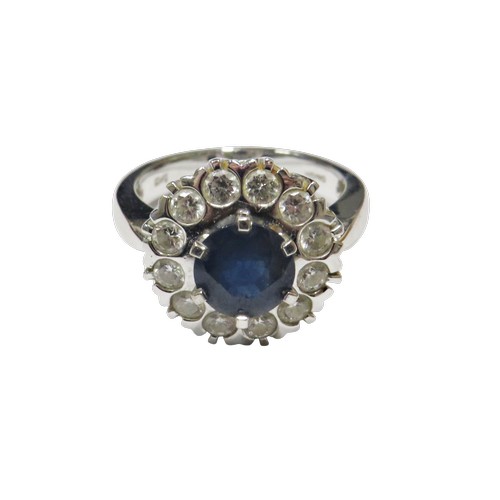 50 - An 18ct white gold, sapphire and diamond cluster ring, centred with a round mixed-cut sapphire appro... 