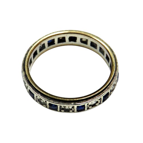 55 - A vintage gold and synthetic blue and white spinel eternity ring, alternately set with square blue a... 