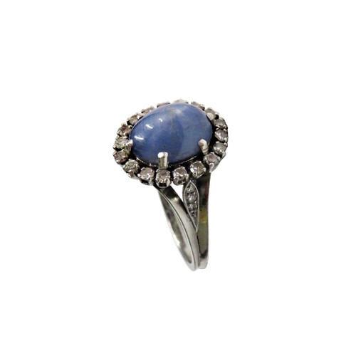 59 - A vintage platinum, 'star' sapphire and diamond oval cluster ring, the grey-ish blue oval cabochon d... 