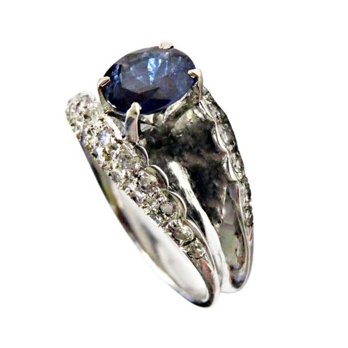 43 - A vintage sapphire and diamond dress ring, claw set at the centre with an oval mixed-cut sapphire on... 
