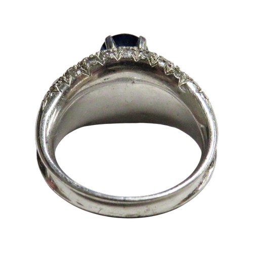 43 - A vintage sapphire and diamond dress ring, claw set at the centre with an oval mixed-cut sapphire on... 