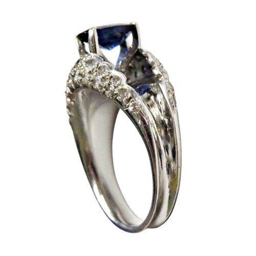 43 - A vintage sapphire and diamond dress ring, claw set at the centre with an oval mixed-cut sapphire on... 
