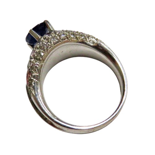43 - A vintage sapphire and diamond dress ring, claw set at the centre with an oval mixed-cut sapphire on... 