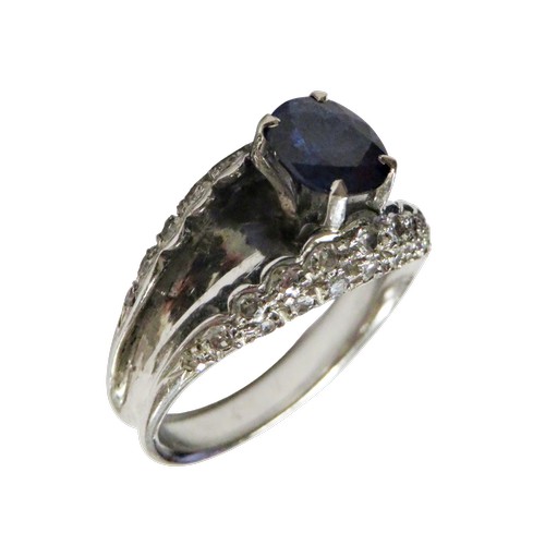 43 - A vintage sapphire and diamond dress ring, claw set at the centre with an oval mixed-cut sapphire on... 