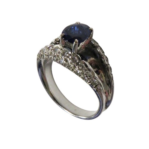 43 - A vintage sapphire and diamond dress ring, claw set at the centre with an oval mixed-cut sapphire on... 