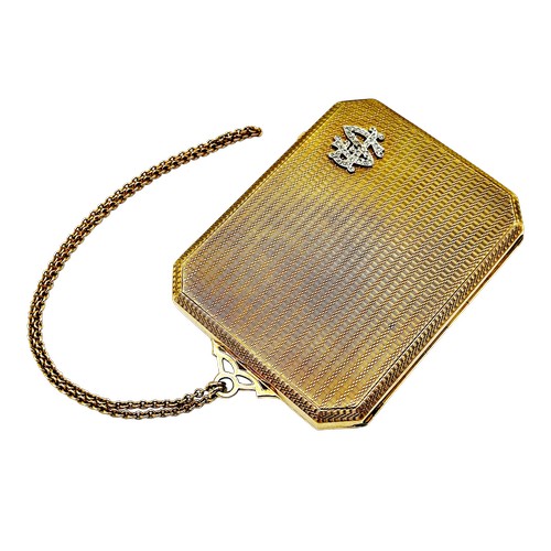243 - An early 20th century  engine-turned 9ct gold canted-rectangular and bevel-edge purse, the front wit... 