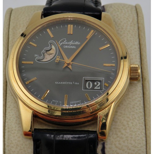 1125 - Glashütte, Senator, Panorama date with moon phase, a gentleman’s 18ct gold wrist watch, signed dark-... 