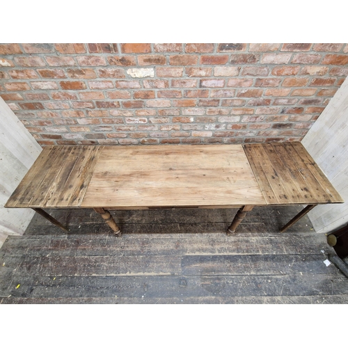 1001 - Antique pine kitchen table with single drawer and additional side extensions, H 71cm x W 130cm (236c... 