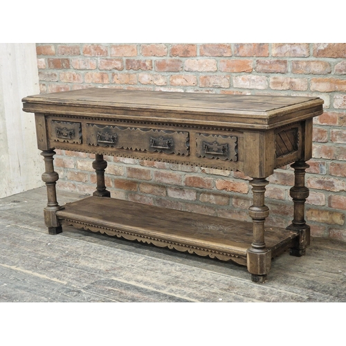 1003 - Antique Gothic oak serving table with three drawers and planked under tier, raised on turned support... 