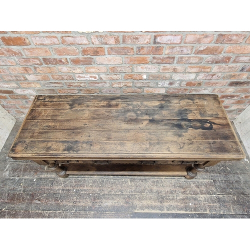 1003 - Antique Gothic oak serving table with three drawers and planked under tier, raised on turned support... 