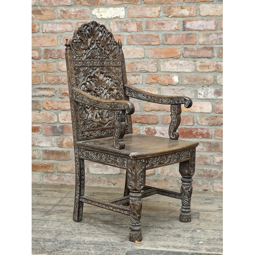 1023 - 19th century Anglo Indian armchair, profusely carved with  pierced floral detail, raised on turned s... 