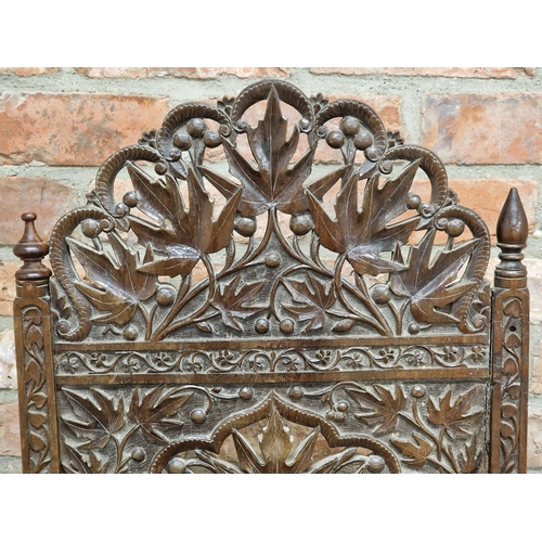 1023 - 19th century Anglo Indian armchair, profusely carved with  pierced floral detail, raised on turned s... 