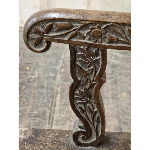 1023 - 19th century Anglo Indian armchair, profusely carved with  pierced floral detail, raised on turned s... 