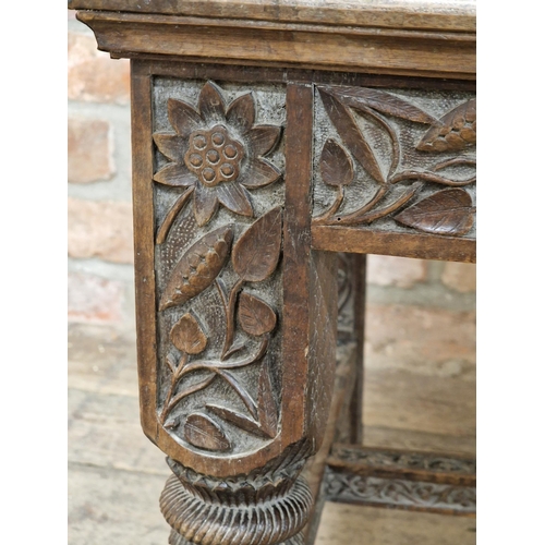 1023 - 19th century Anglo Indian armchair, profusely carved with  pierced floral detail, raised on turned s... 