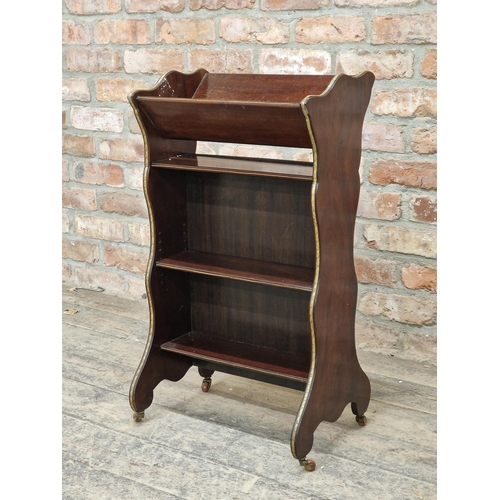 1057 - Edwardian mahogany book trough, raised on ceramic castors, H 78cm x W 43cm x D 28cm