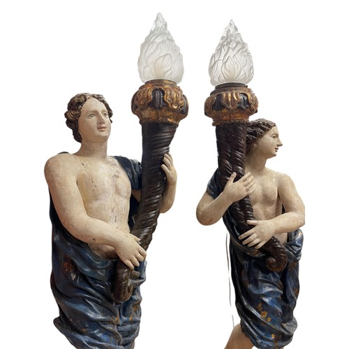 1 - A superb grand scale pair of 17th Century Venetian floor standing painted wood figural torcheres, wi... 