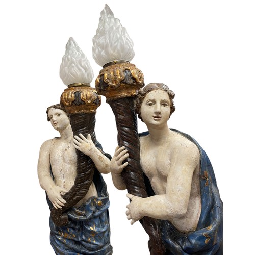 1 - A superb grand scale pair of 17th Century Venetian floor standing painted wood figural torcheres, wi... 