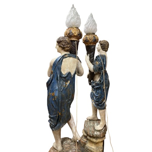1 - A superb grand scale pair of 17th Century Venetian floor standing painted wood figural torcheres, wi... 