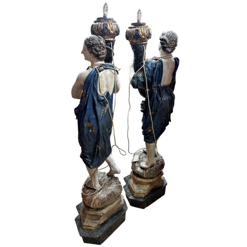 1 - A superb grand scale pair of 17th Century Venetian floor standing painted wood figural torcheres, wi... 