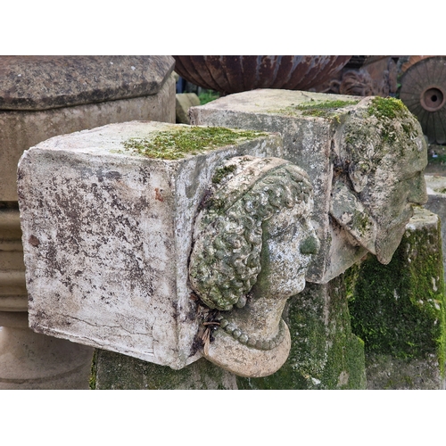 14 - Two weathered reconstituted stone male and female face mask corbels, H 32cm x W 28cm x D 35cm (2)