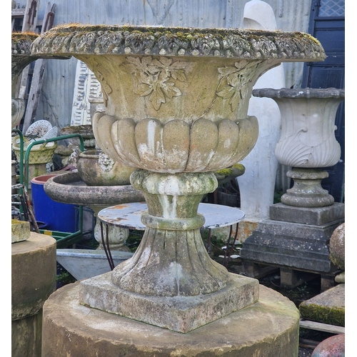 21 - Pair of well weathered two sectional reconstituted stone garden urns with lobed bowls and foliate re... 