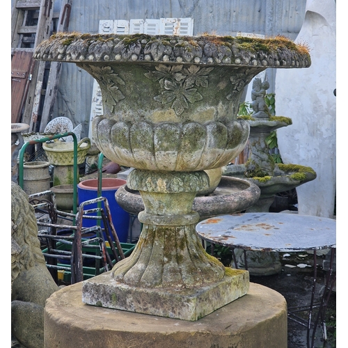 21 - Pair of well weathered two sectional reconstituted stone garden urns with lobed bowls and foliate re... 