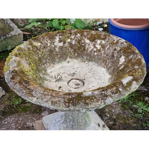 41 - Well weathered reconstituted stone urn with lobed bowl and fluted socle, raised on a square cut plin... 